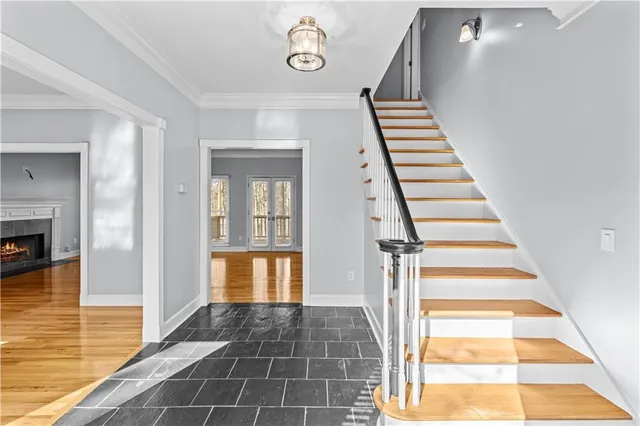 a view of a hallway with wooden floor and staircase