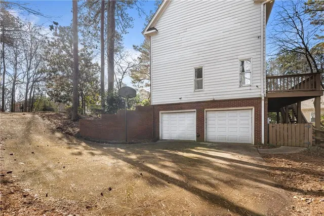 a view of a house with a yard and garage