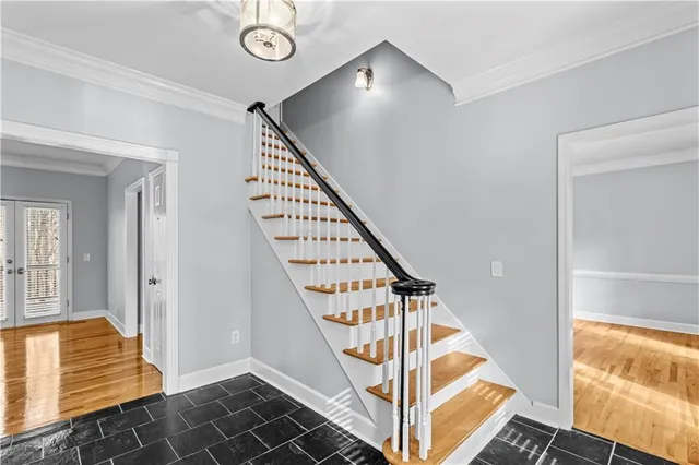 a view of an entryway with wooden floor and door