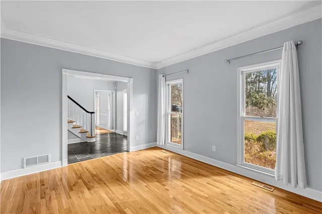 a bedroom with a bed and a large window with outer view