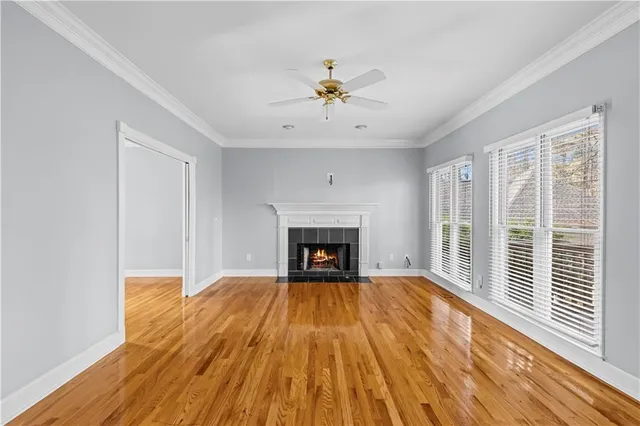 a view of a livingroom with a fireplace a chandelier and wooden floor