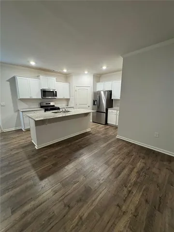 a kitchen with stainless steel appliances a refrigerator sink and microwave