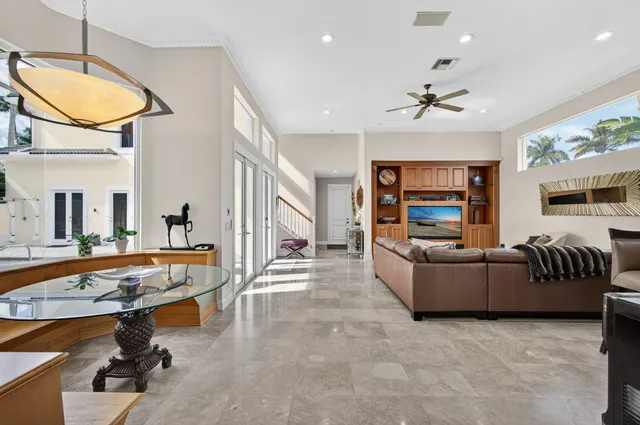 a living room with furniture large window and flat screen tv