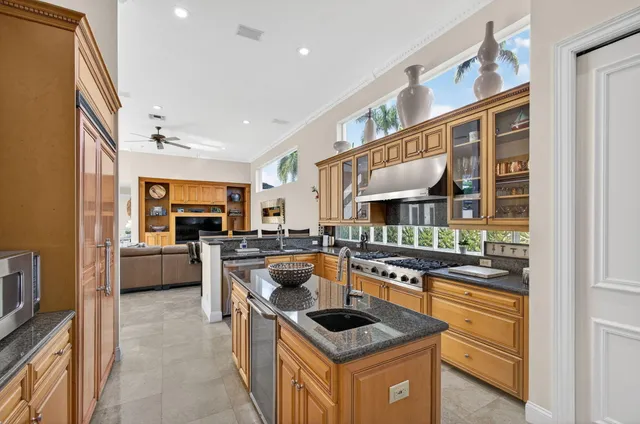 a bathroom with a granite countertop sink mirror vanity and toilet