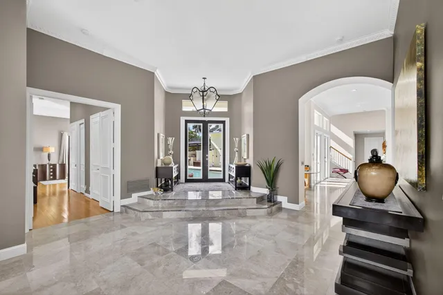 a bedroom with a large bed and a large window with outer view