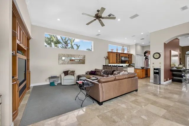a living room with furniture ceiling fan and a chandelier
