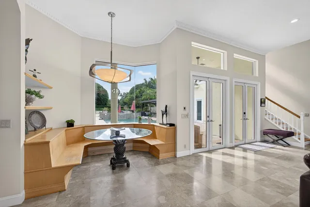 a kitchen with stainless steel appliances granite countertop a refrigerator a stove and a sink with large window