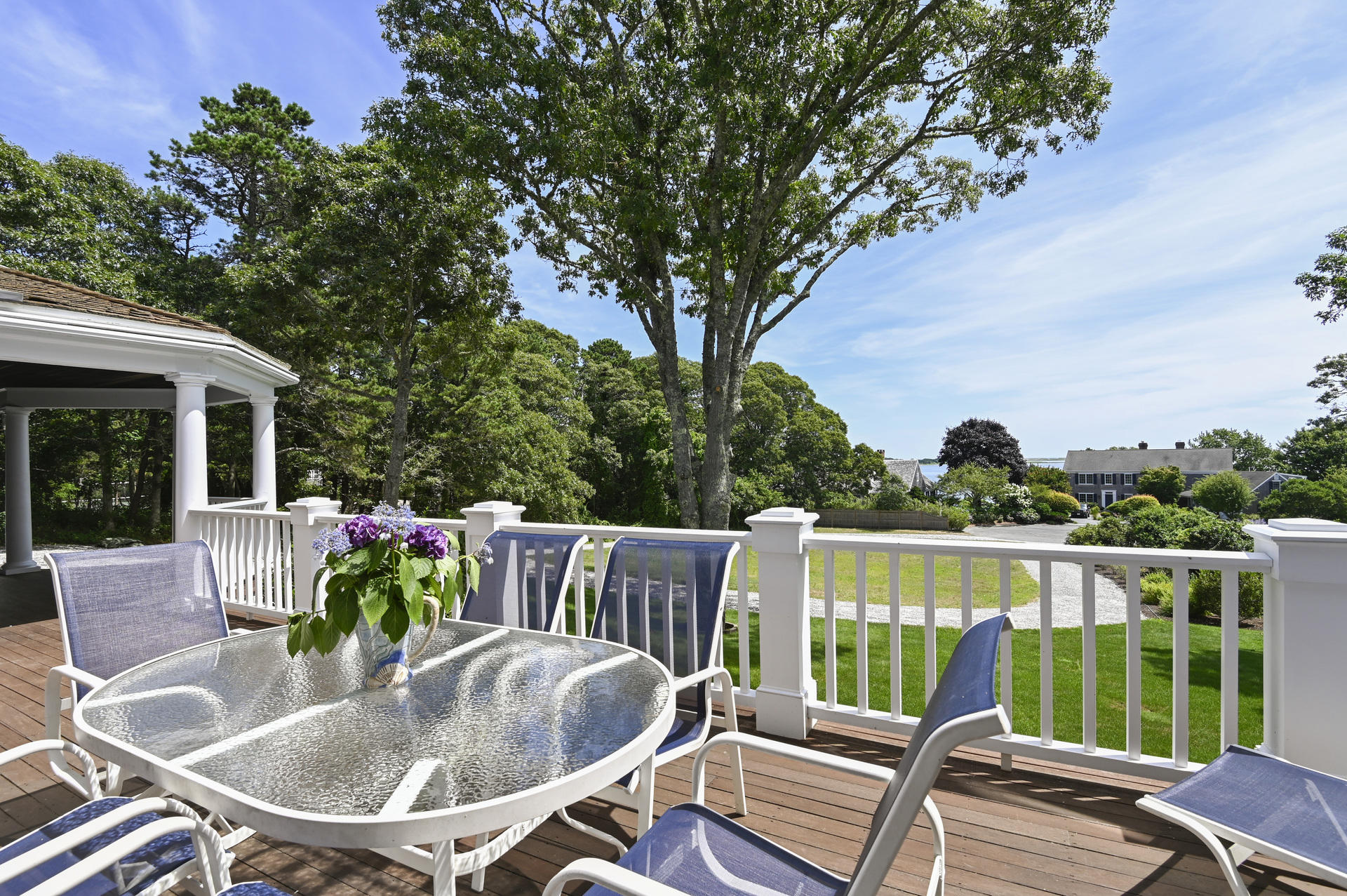 22 Little Bay Road Orleans, MA 02653 - Photo 11 of 39 a view of a patio with table and chairs potted plants with wooden floor and fence