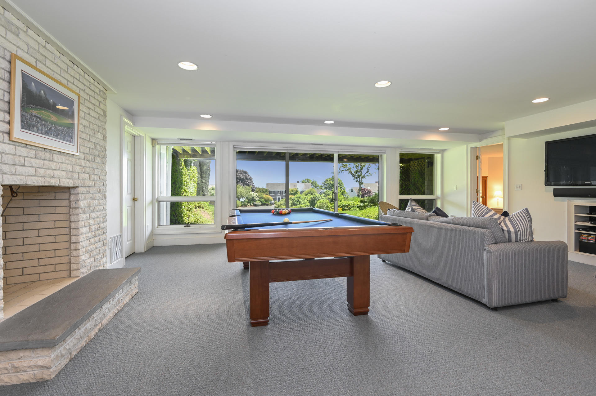 22 Little Bay Road Orleans, MA 02653 - Photo 27 of 39 a living room with furniture a fireplace and a flat screen tv
