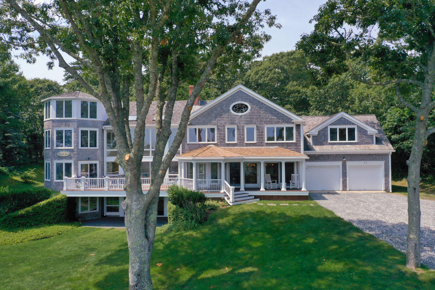 22 Little Bay Road Orleans, MA 02653 - Photo 6 of 39 a front view of a house with a yard table and chairs