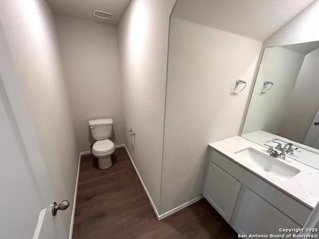 a bathroom with a sink toilet and vanity