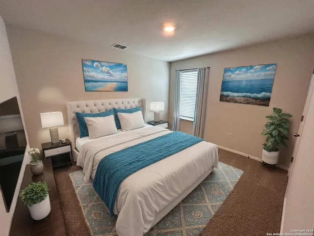 a bedroom with a bed and painting on the wall