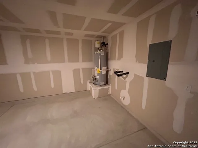 a view of an empty room with wooden floor and white cabinet