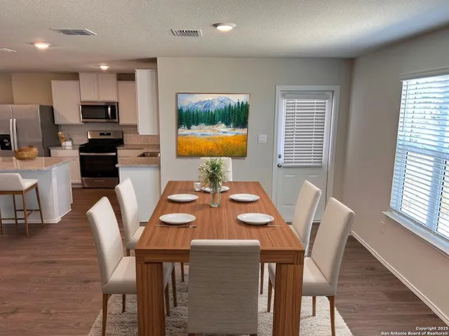 a view of a dining room with furniture and a window
