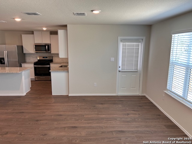 3815 Rusted Copper Bulverde, TX 78163 - Photo 6 of 36 a view of kitchen with wooden floor electronic appliances and window