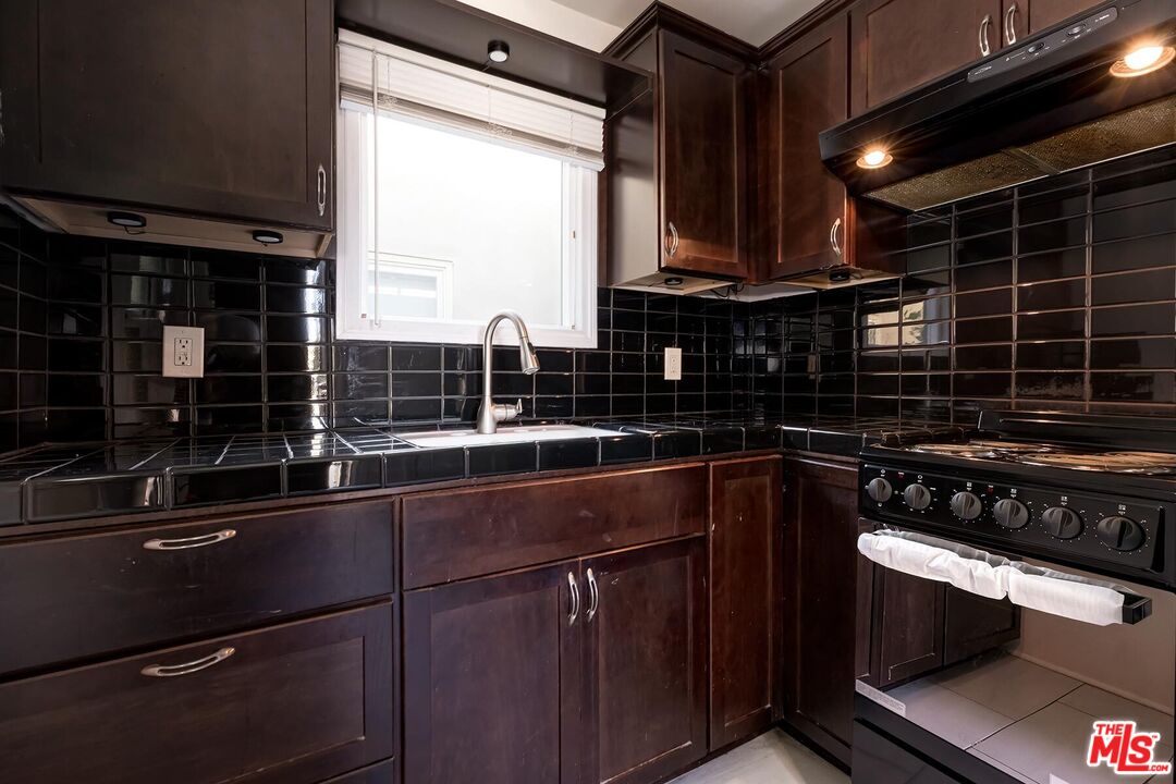1054 Maine Avenue, Unit 3 Long Beach, CA 90813 - Photo 11 of 13 a kitchen with a sink and cabinets