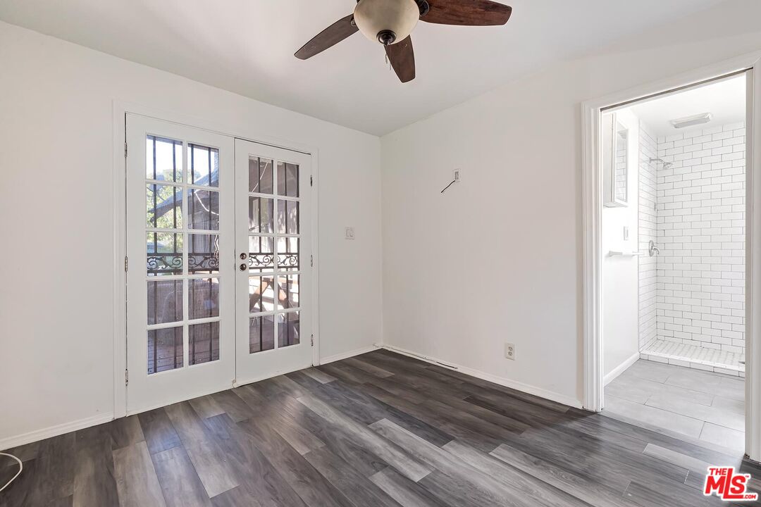 1054 Maine Avenue, Unit 3 Long Beach, CA 90813 - Photo 9 of 13 an empty room with wooden floor and windows