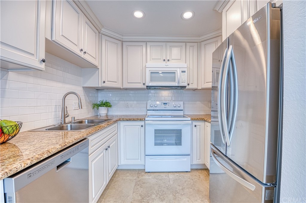 33782 Malaga Drive, Unit A Dana Point, CA 92629 - Photo 5 of 17 a kitchen with stainless steel appliances granite countertop a refrigerator sink and cabinets