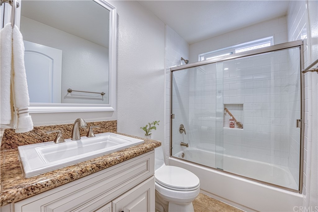 33782 Malaga Drive, Unit A Dana Point, CA 92629 - Photo 10 of 17 a bathroom with a granite countertop sink toilet and shower