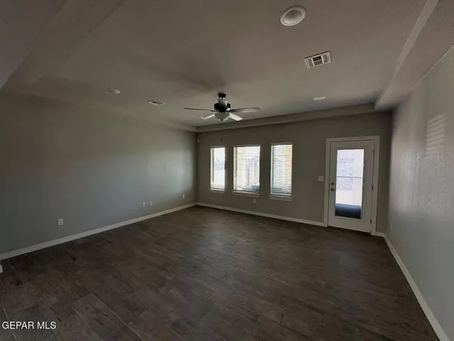 an empty room with a empty space and windows