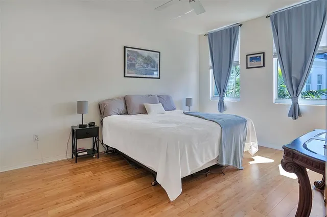 a bedroom with a bed and a painting on the wall