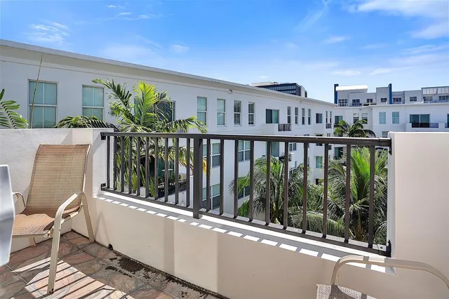 a view of a balcony with chairs