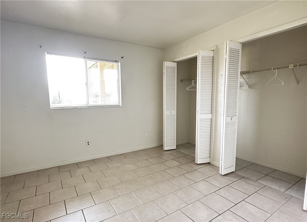 4613 Southwest 8th Place, Unit 4 Cape Coral, FL 33914 - Photo 7 of 16 an empty room with windows