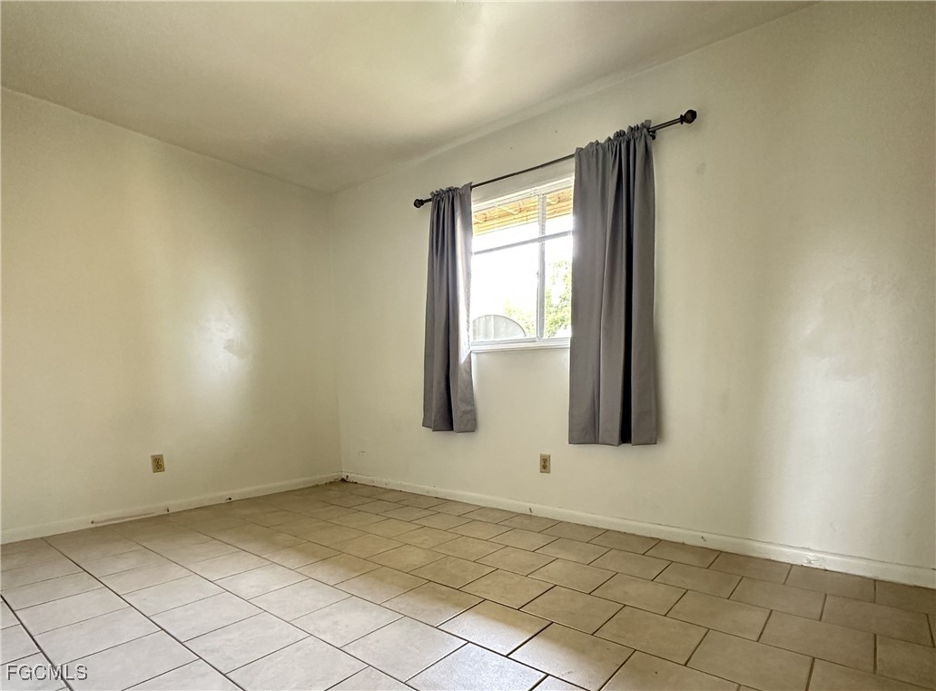 4613 Southwest 8th Place, Unit 4 Cape Coral, FL 33914 - Photo 9 of 16 an empty room with windows