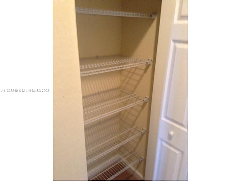 8946 West 35th Way Hialeah, FL 33018 - Photo 14 of 25 a view of walk in closet with empty racks