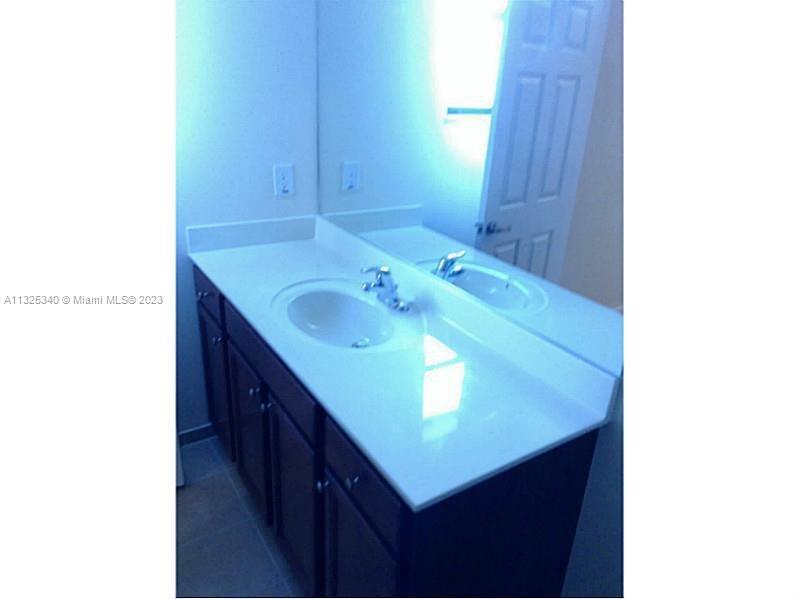 8946 West 35th Way Hialeah, FL 33018 - Photo 22 of 25 a bathroom with a sink and a mirror