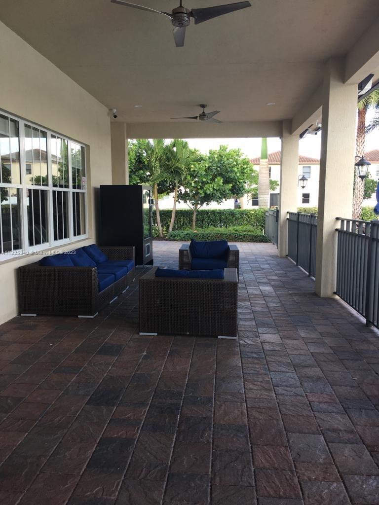 8946 West 35th Way Hialeah, FL 33018 - Photo 4 of 25 a living room with patio furniture and a floor to ceiling window