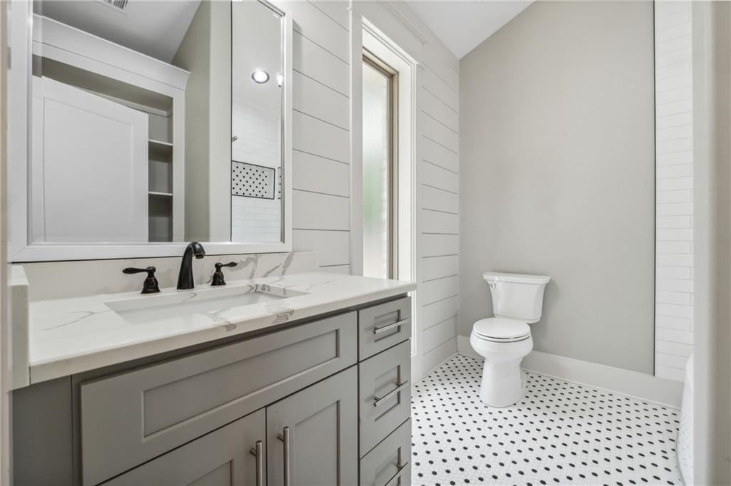 852 Tom Miller Road Bethlehem, GA 30620 - Photo 54 of 68 a bathroom with a granite countertop sink a toilet and a mirror
