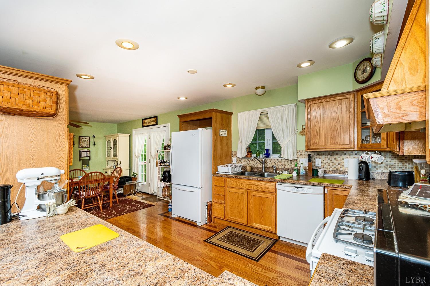 552 Pendleton Drive Amherst, VA 24521 - Photo 11 of 58 a view of a kitchen with kitchen island dining table and a refrigerator