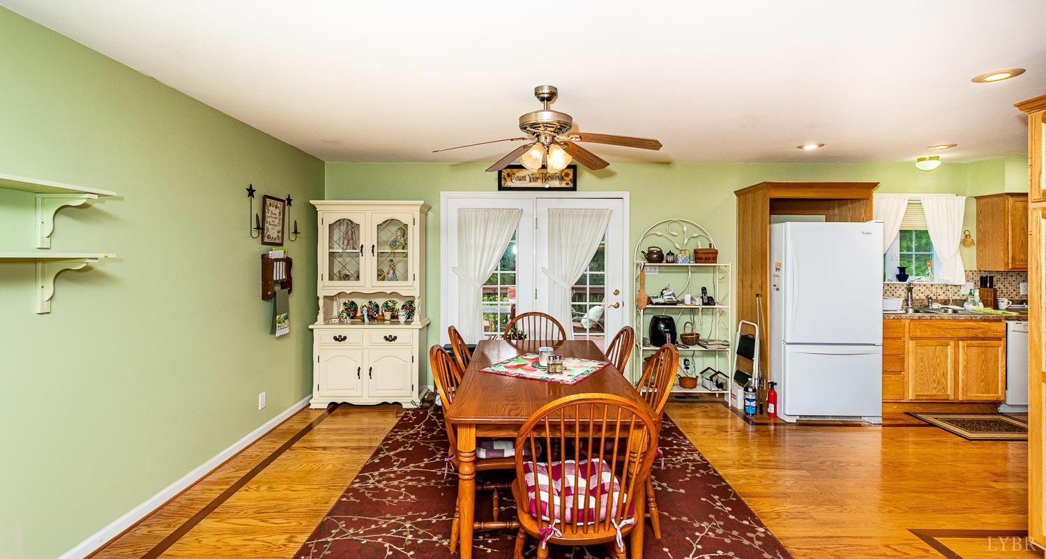 552 Pendleton Drive Amherst, VA 24521 - Photo 18 of 58 a dining room with wooden floor and a chandelier
