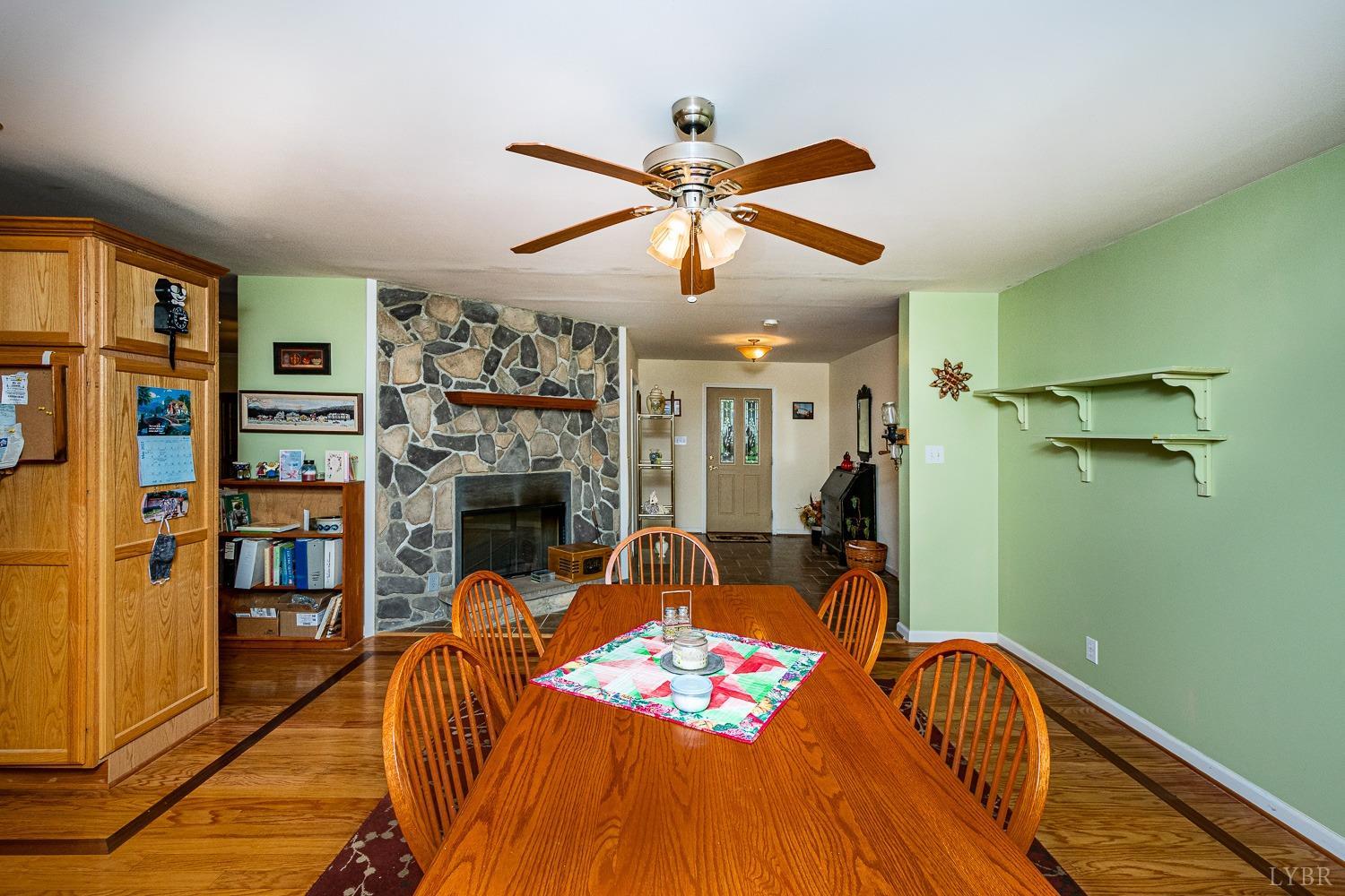 552 Pendleton Drive Amherst, VA 24521 - Photo 28 of 58 a living room with furniture a fireplace and a chandelier