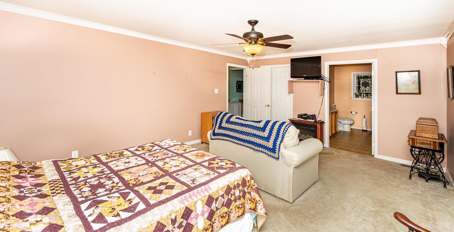 552 Pendleton Drive Amherst, VA 24521 - Photo 33 of 58 a bedroom with a bed and a chandelier