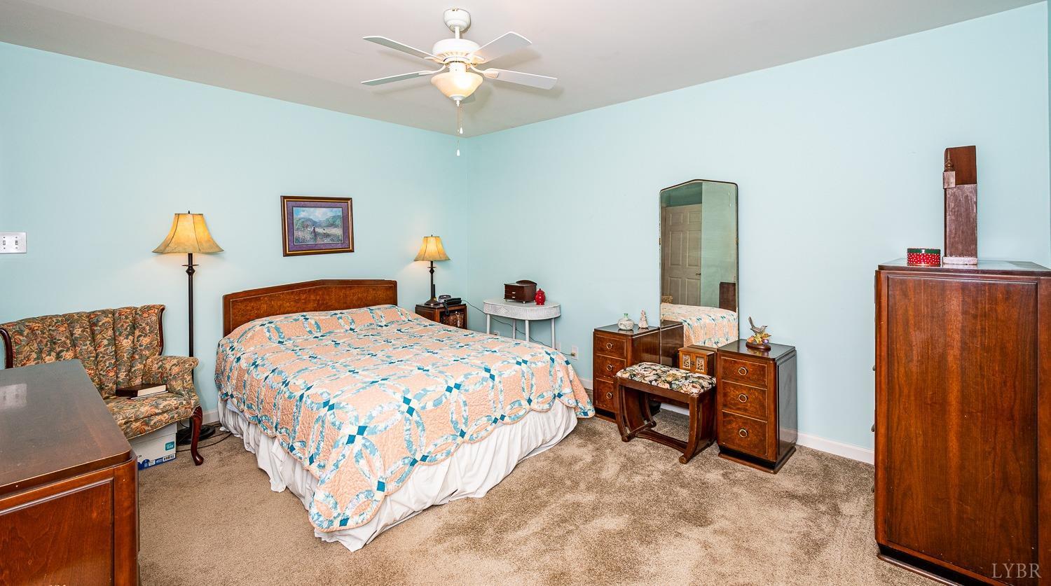 552 Pendleton Drive Amherst, VA 24521 - Photo 35 of 58 a bedroom with a bed and a chandelier