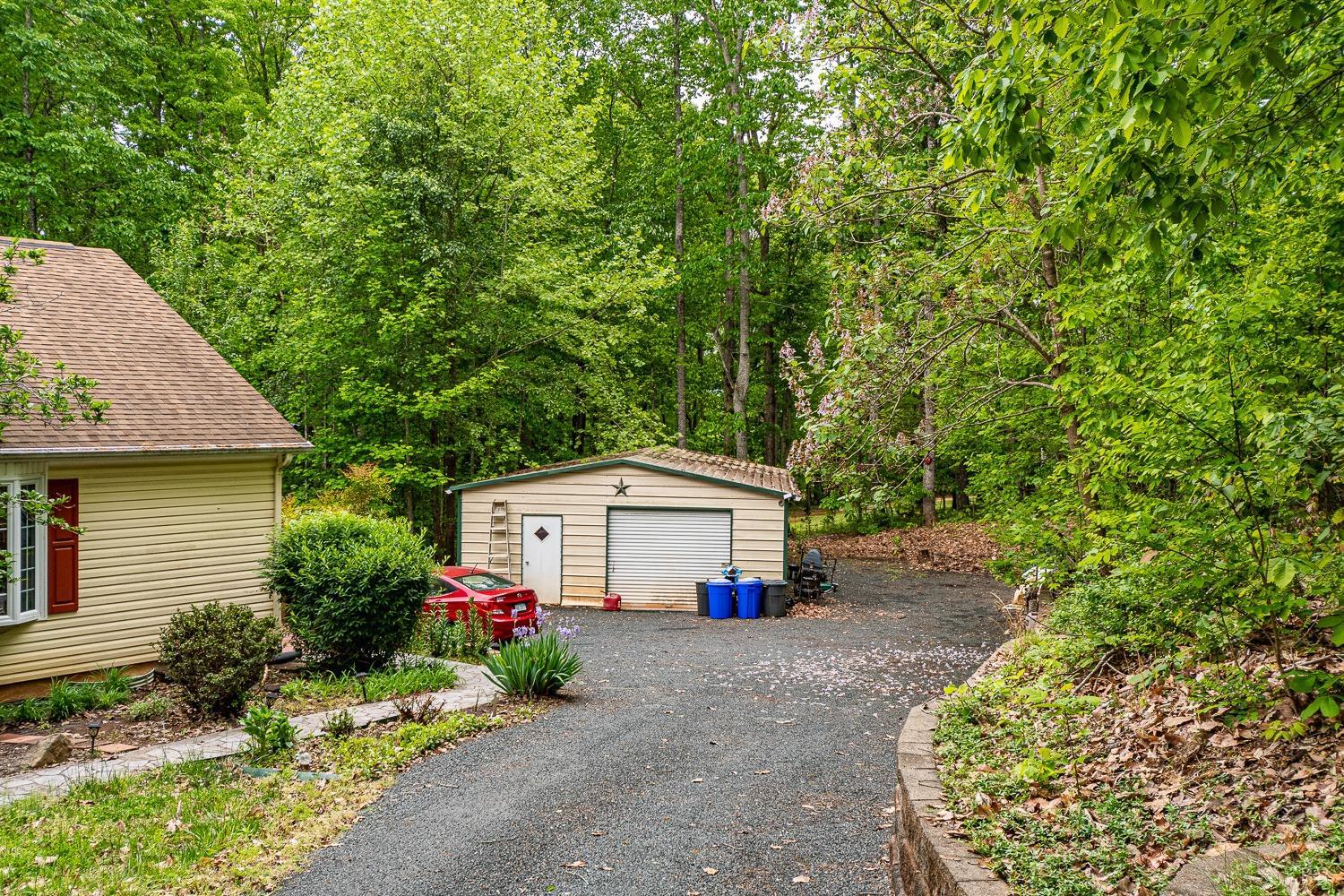 552 Pendleton Drive Amherst, VA 24521 - Photo 54 of 58 a front view of a house with a garden and trees