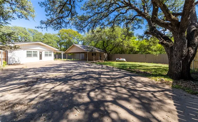 a view of a house with a yard and garage