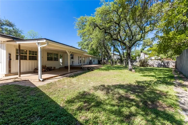 a view of a house with backyard and sitting area