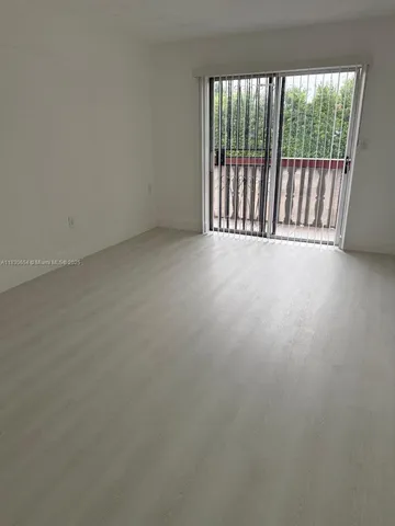 a view of an empty room with a balcony