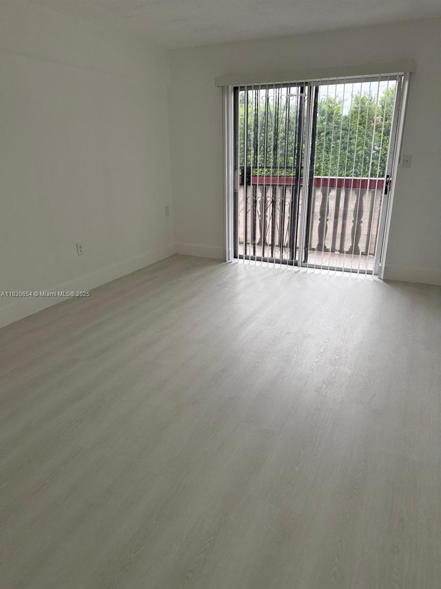 1000 West 28th Street, Unit 15 Hialeah, FL 33010 - Photo 2 of 10 a view of an empty room with a balcony