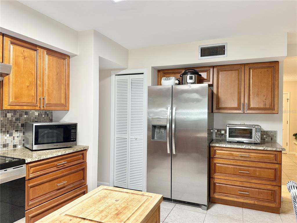 6101 Soaring Avenue Temple Terrace, FL 33617 - Photo 12 of 53 a kitchen with stainless steel appliances granite countertop a refrigerator and a stove top oven