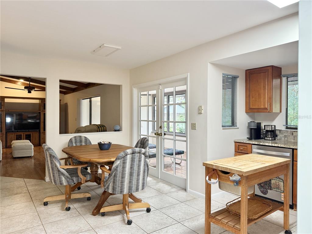 6101 Soaring Avenue Temple Terrace, FL 33617 - Photo 14 of 53 a living room with a stove a table and chairs in it