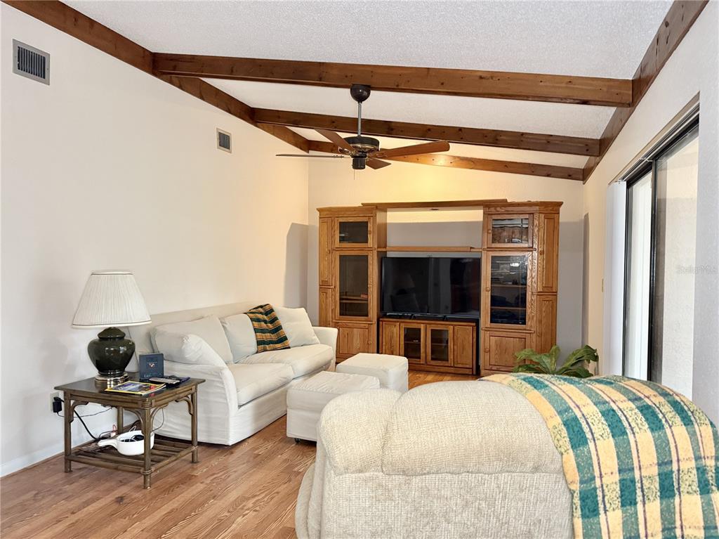 6101 Soaring Avenue Temple Terrace, FL 33617 - Photo 17 of 53 a bedroom with furniture and wooden floor