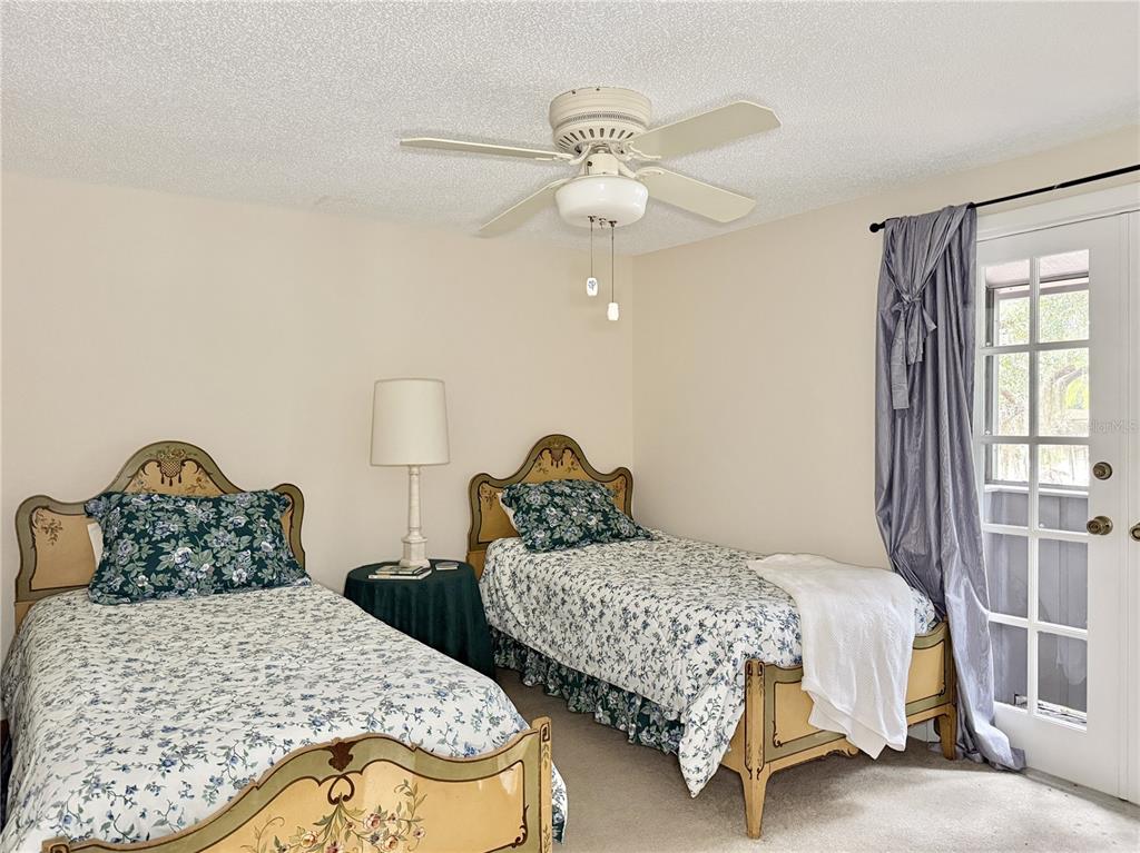 6101 Soaring Avenue Temple Terrace, FL 33617 - Photo 27 of 53 a bedroom with two beds and a chandelier