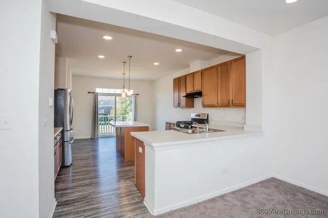a kitchen with sink cabinets and wooden floor