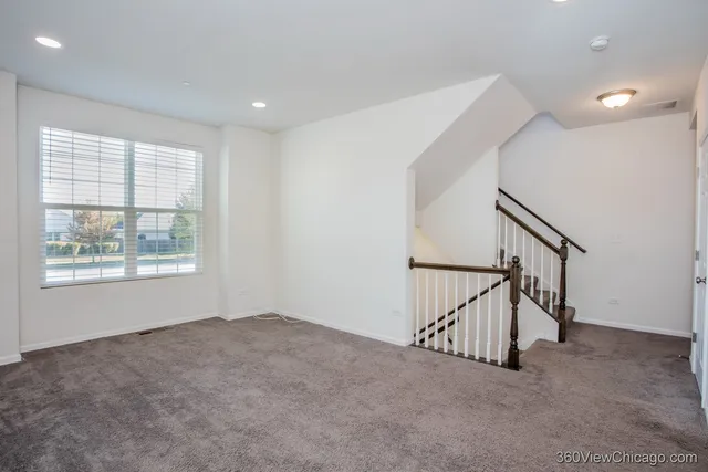a view of an empty room with stairs