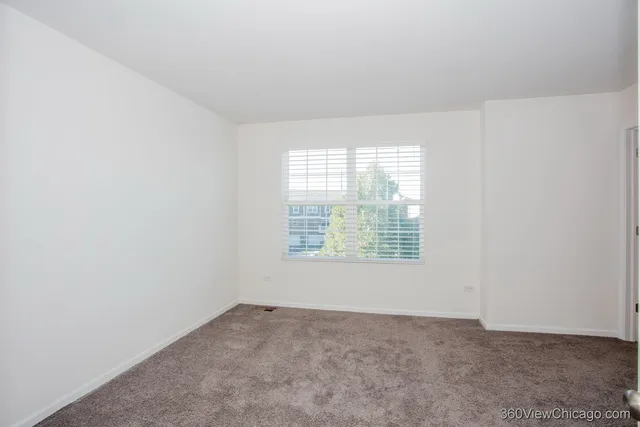 an empty room with a empty space and windows