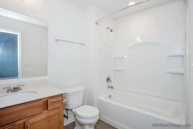 a bathroom with a granite countertop toilet a sink and a bathtub